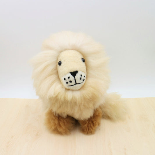 Handcrafted alpaca stuffed animal lion with fluffy cream mane, brown body, and adorable embroidered face. Eco-friendly, fair trade plush toy made from natural, sustainable materials. Perfect for cuddling or home decor.